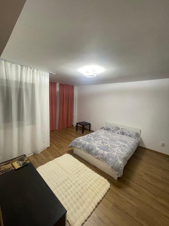 a bedroom with a bed and a table in it at GD House in Bucharest