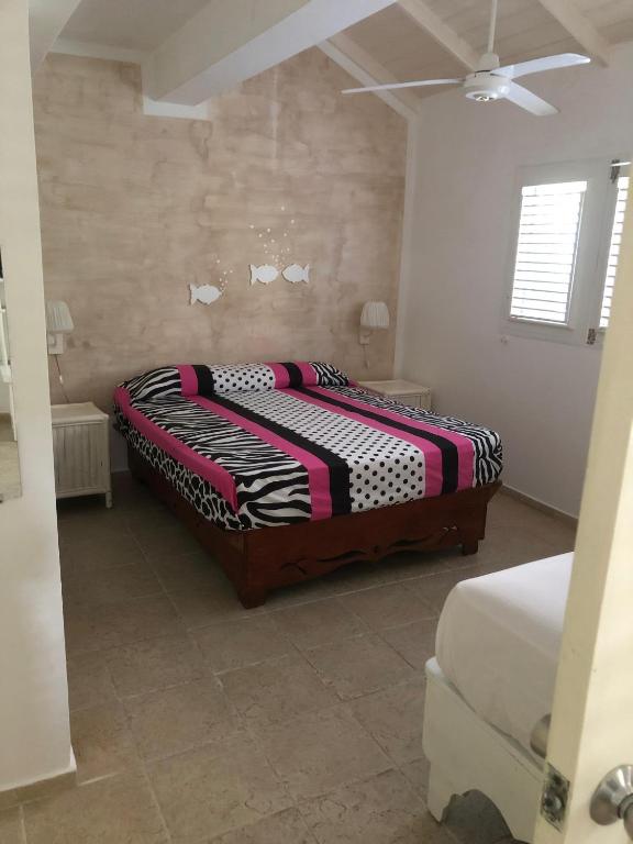 Postel nebo postele na pokoji v ubytování Hotel Casa Robinson