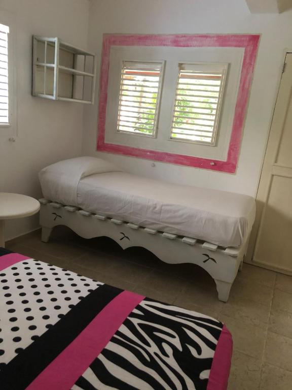 Postel nebo postele na pokoji v ubytování Hotel Casa Robinson