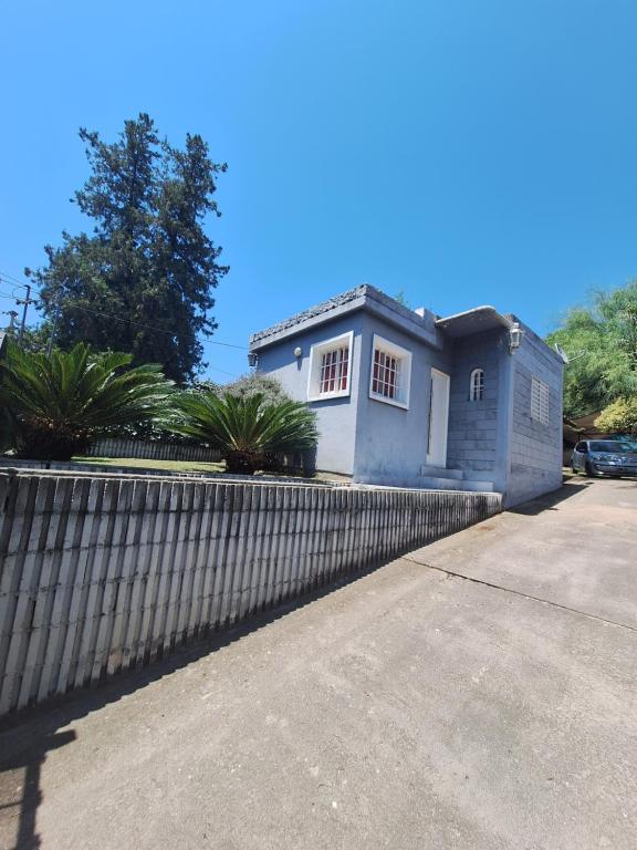 a small blue house with a fence at Terraza Perito Moreno in Villa Carlos Paz