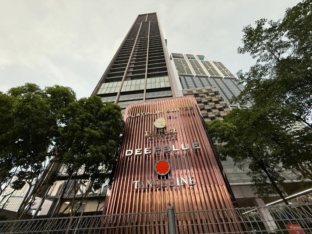 a tall building with a sign on the side of it at The Suites At Platinum KLCC in Kuala Lumpur