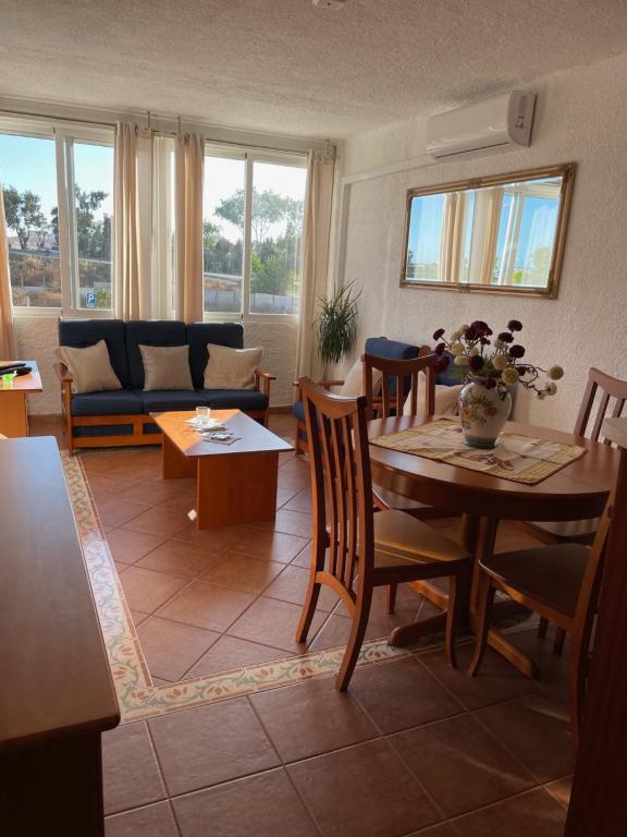 a living room with a table and a couch at Olhao Apartment in Olhão