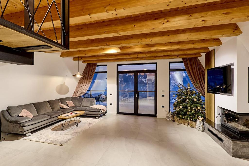 a living room with a couch and a christmas tree at Cabana Ana in Borşa