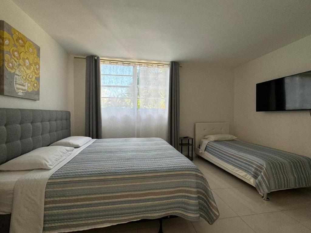 Кровать или кровати в номере Ocean front 1 bedroom in Tropical Paradise