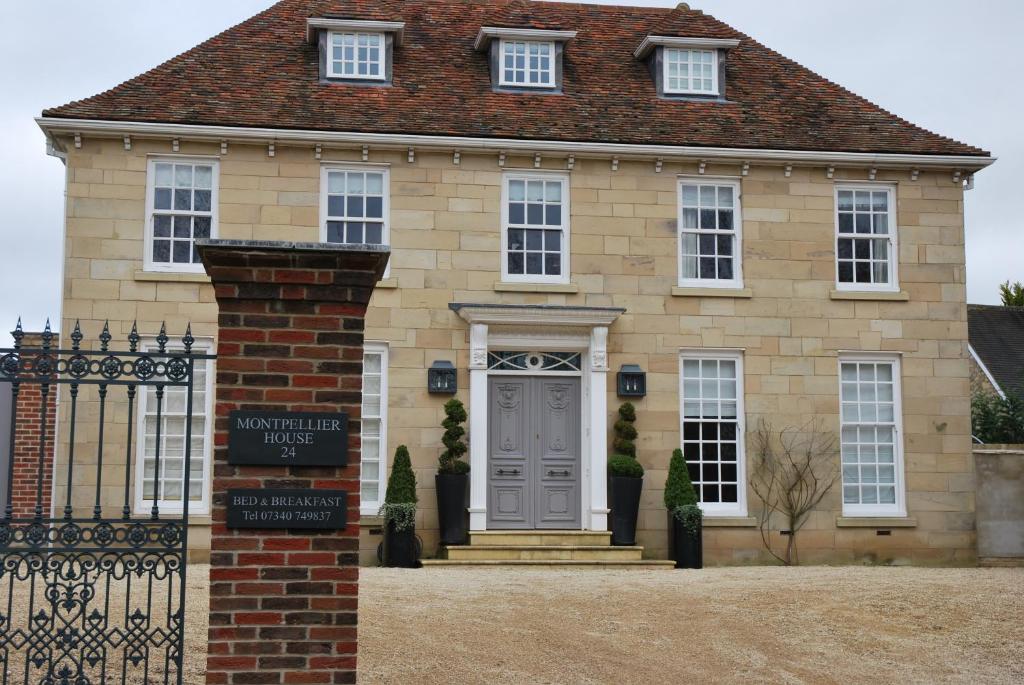 a house with a sign in front of it at Montpellier House in Milton Keynes