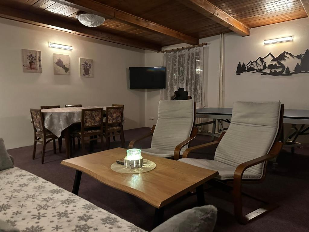 a living room with a table and chairs at Chata Slunečná louka in Cerny Dul