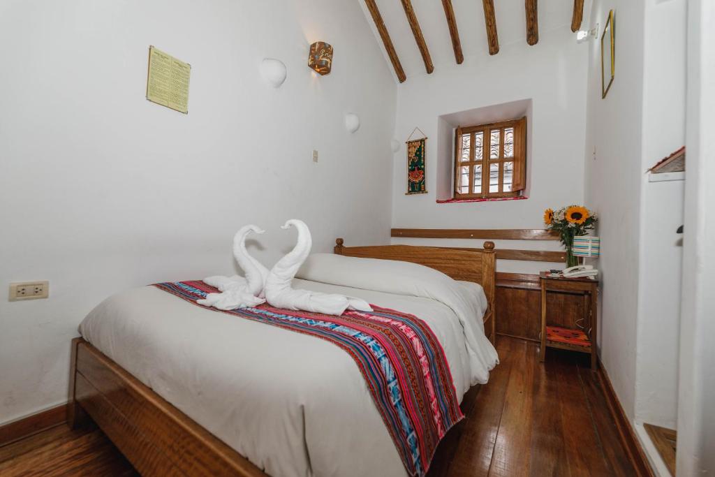 Postel nebo postele na pokoji v ubytování Hostal El Grial