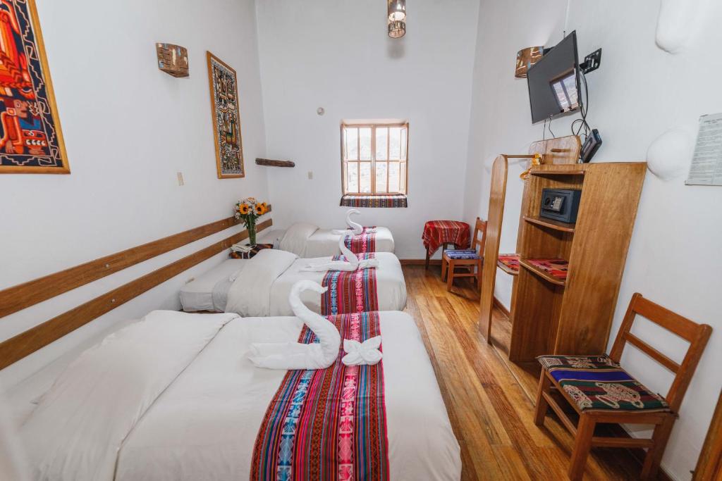 Postel nebo postele na pokoji v ubytování Hostal El Grial