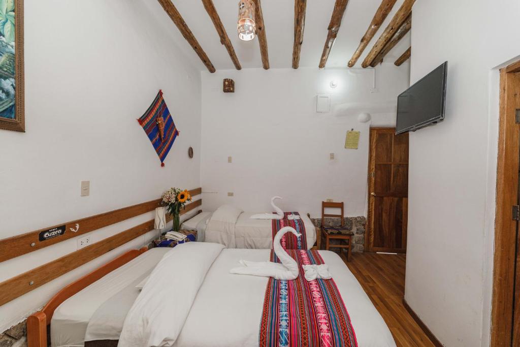 Postel nebo postele na pokoji v ubytování Hostal El Grial
