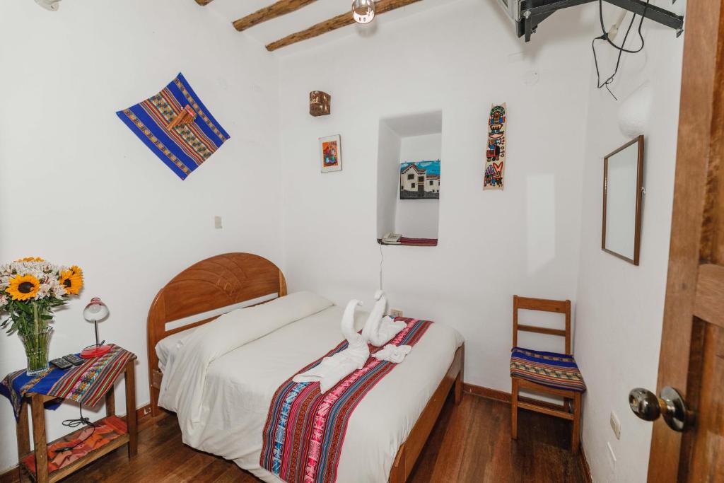 Postel nebo postele na pokoji v ubytování Hostal El Grial