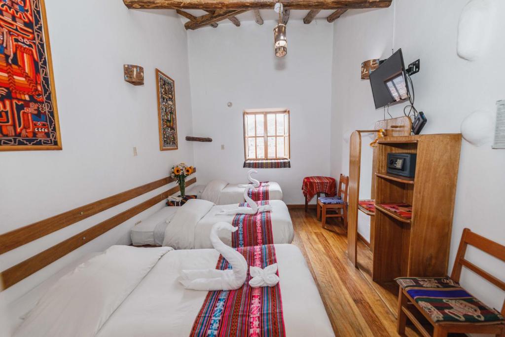 Postel nebo postele na pokoji v ubytování Hostal El Grial
