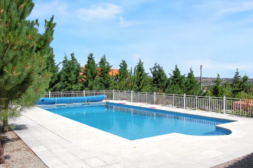 a swimming pool with a fence around it at Spacious house with mountain view in Vila Fernando in Vila Fernando