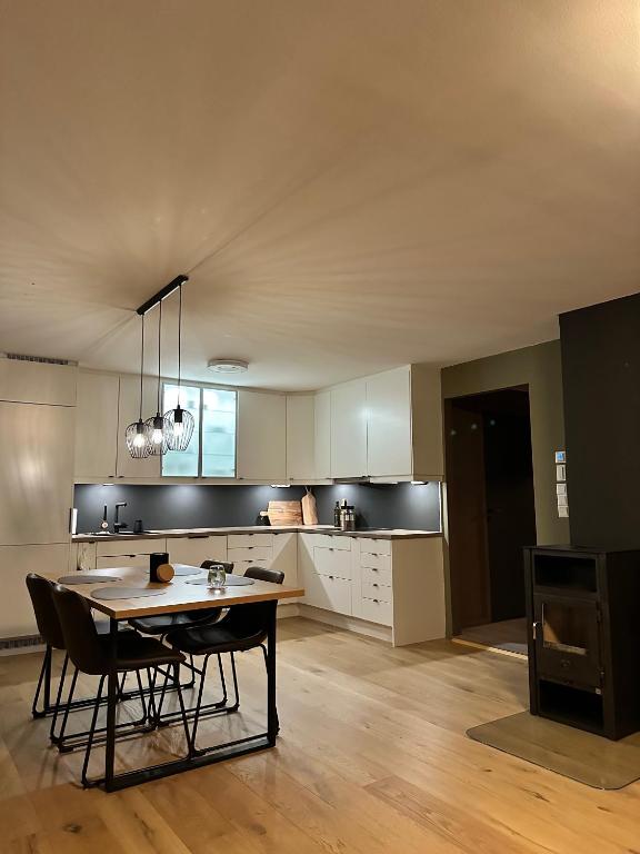 a kitchen with a table and chairs in a room at Modern apartement with parking in Kvaloysletta