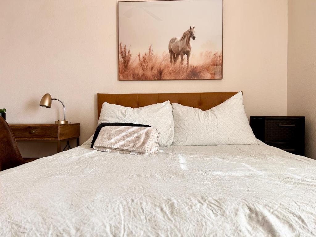 a bedroom with a bed with a picture of a horse at Starlight Western Room in Hemet