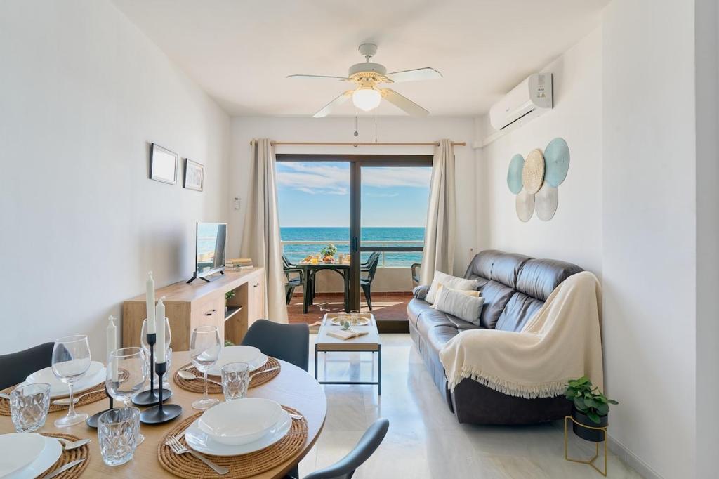 a living room with a couch and a table at ROSE I Vistas and direct access to the sea Mijas Costa in Málaga