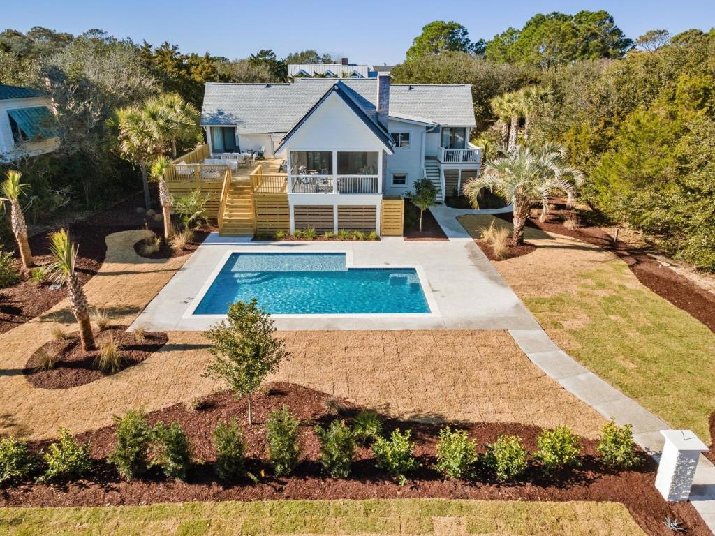 a house with a swimming pool in a yard at High Seas in DeBordieu Colony home by Peace Vacations in Georgetown
