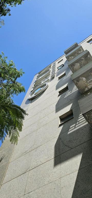 a tall building with windows on the side of it at Option Full Service Residence in Rio de Janeiro