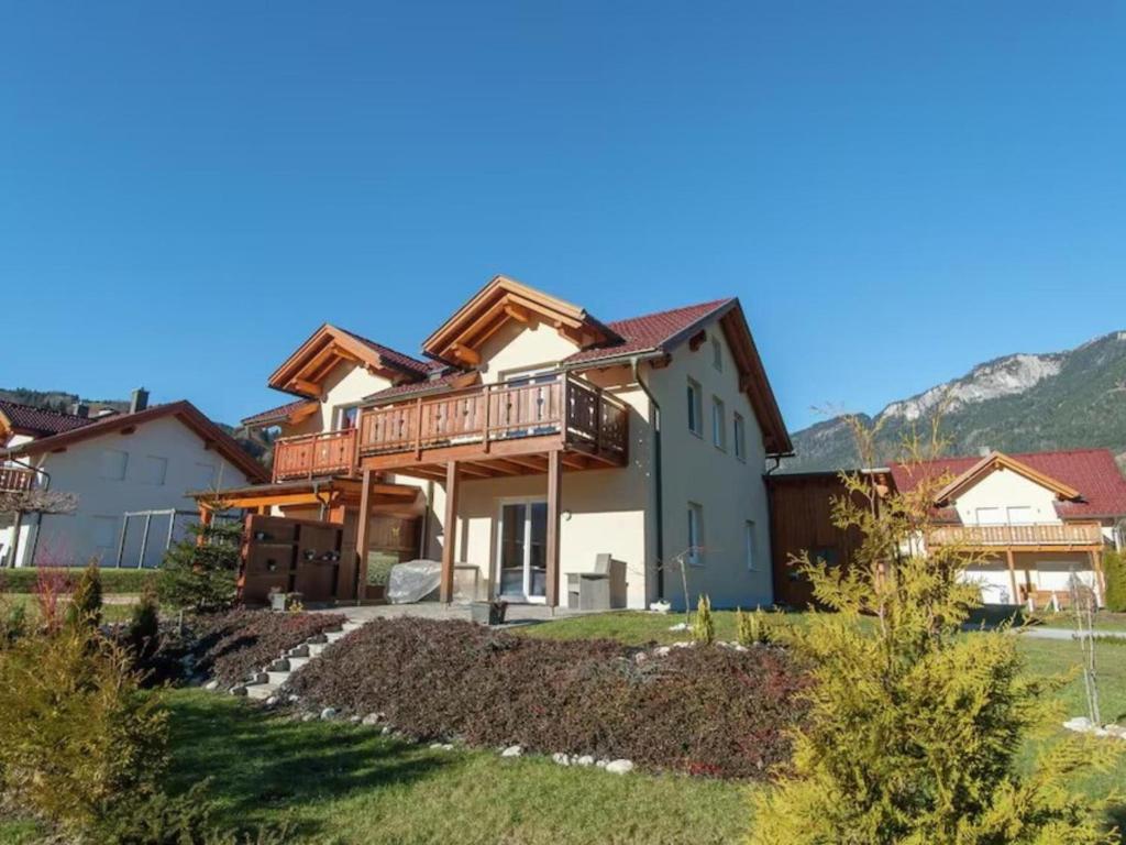 a house in the mountains with a deck at Chalet am Sonnenpiste in Kötschach