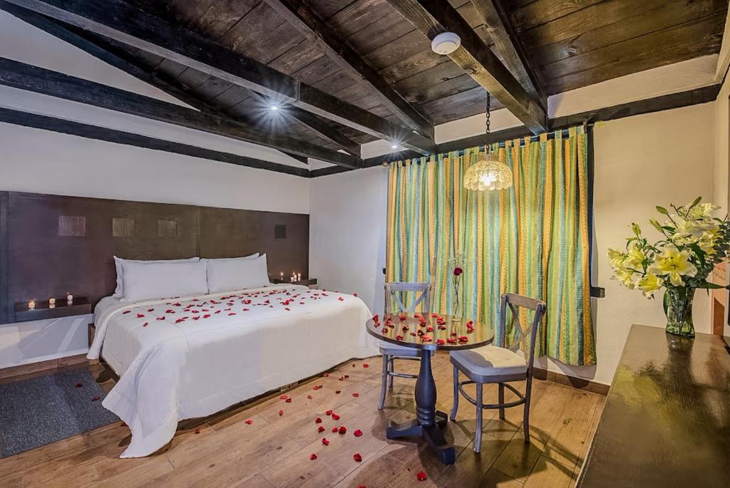 Postel nebo postele na pokoji v ubytování Hotel Chocolate Carruaje
