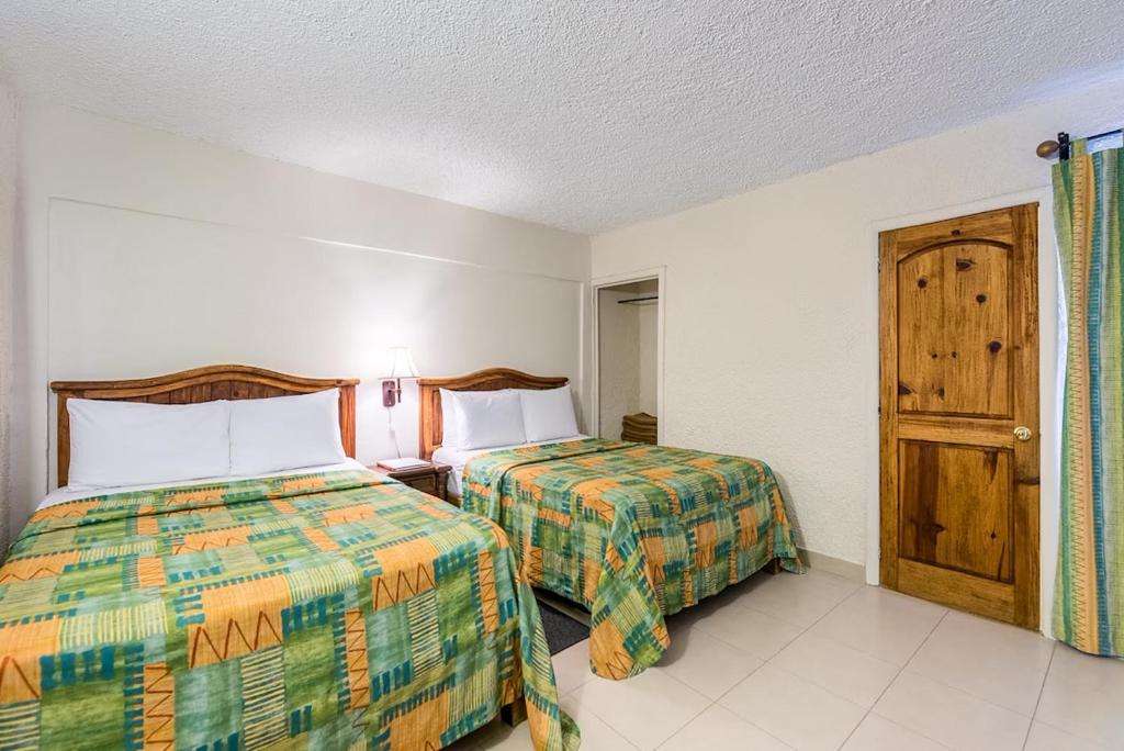Postel nebo postele na pokoji v ubytování Hotel Chocolate Carruaje