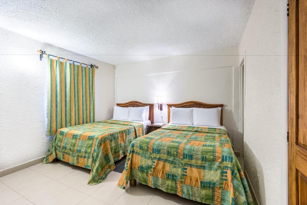 Postel nebo postele na pokoji v ubytování Hotel Chocolate Carruaje