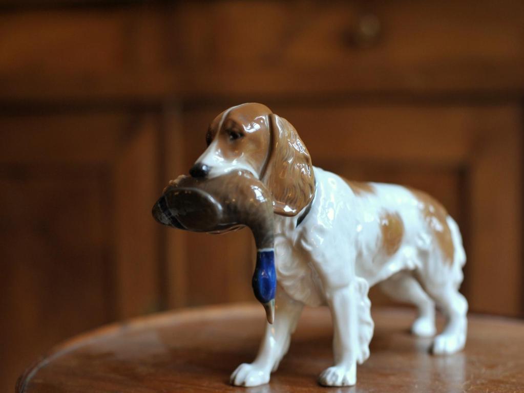 a figurine of a dog with a toy in its mouth at Le Jardin Cathedrale in Chartres