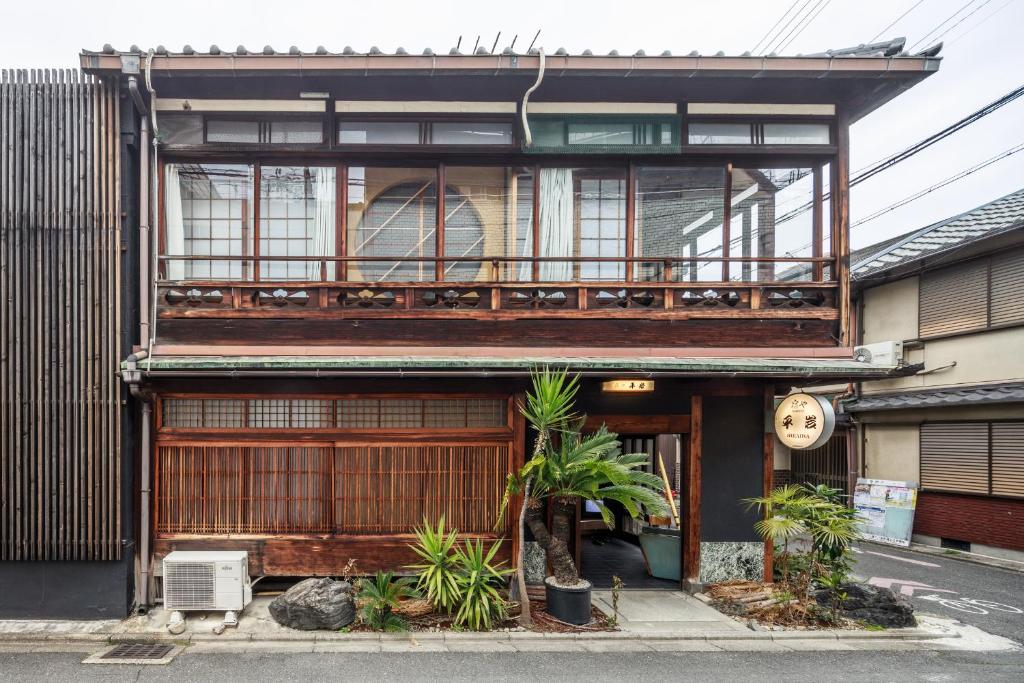 a building with a balcony on top of it at Yadoya Hiraiwa private ryokan in Kyoto