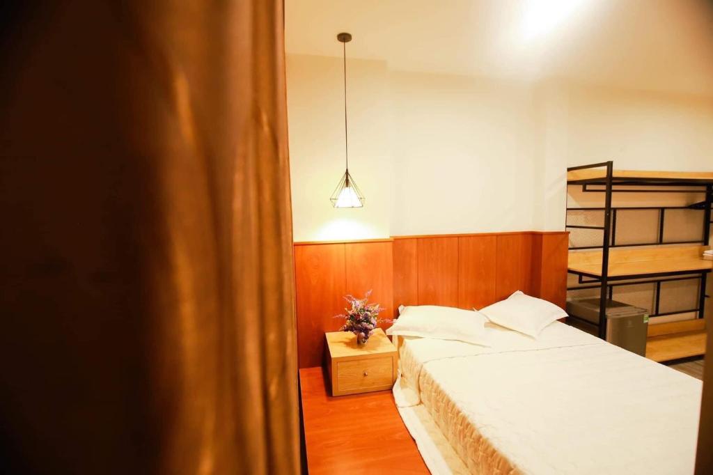 Postel nebo postele na pokoji v ubytování Hoàng Bách Hotel Vũng Tàu