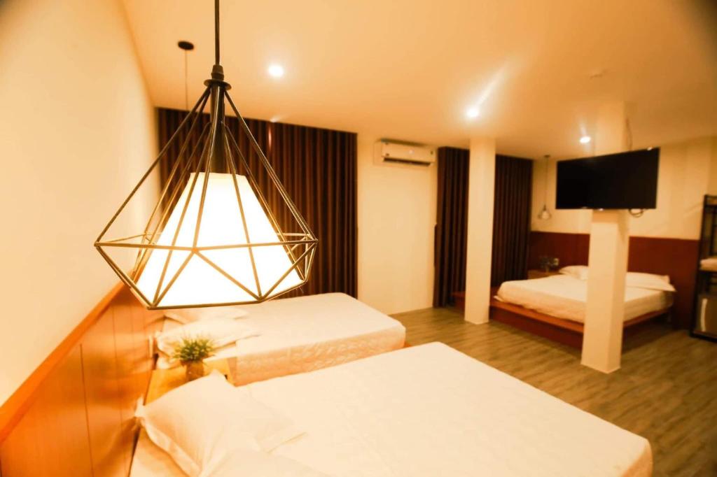 Postel nebo postele na pokoji v ubytování Hoàng Bách Hotel Vũng Tàu