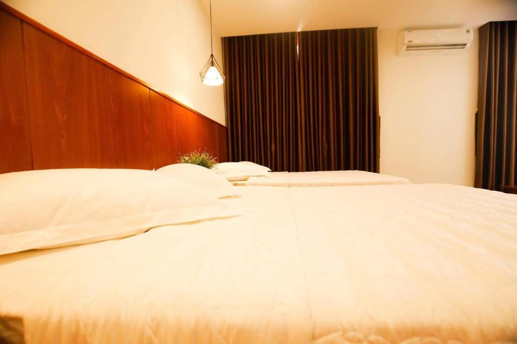 Postel nebo postele na pokoji v ubytování Hoàng Bách Hotel Vũng Tàu