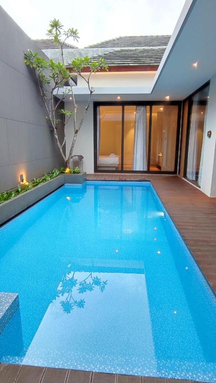 a large blue swimming pool in a house at UU villa at kingspark 8 in Batu