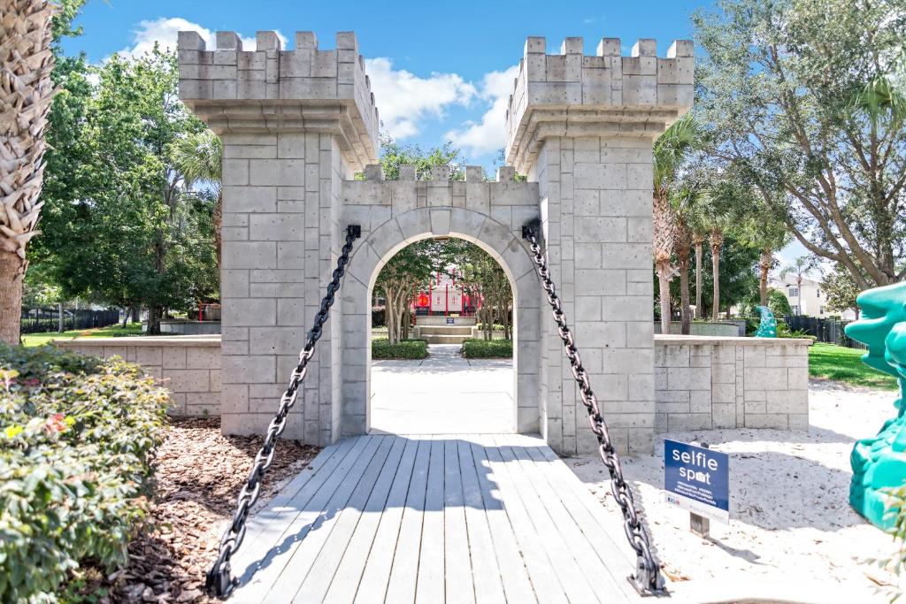 a gate in a fake castle with a chain at The Pink House at Windsor Hills in Orlando