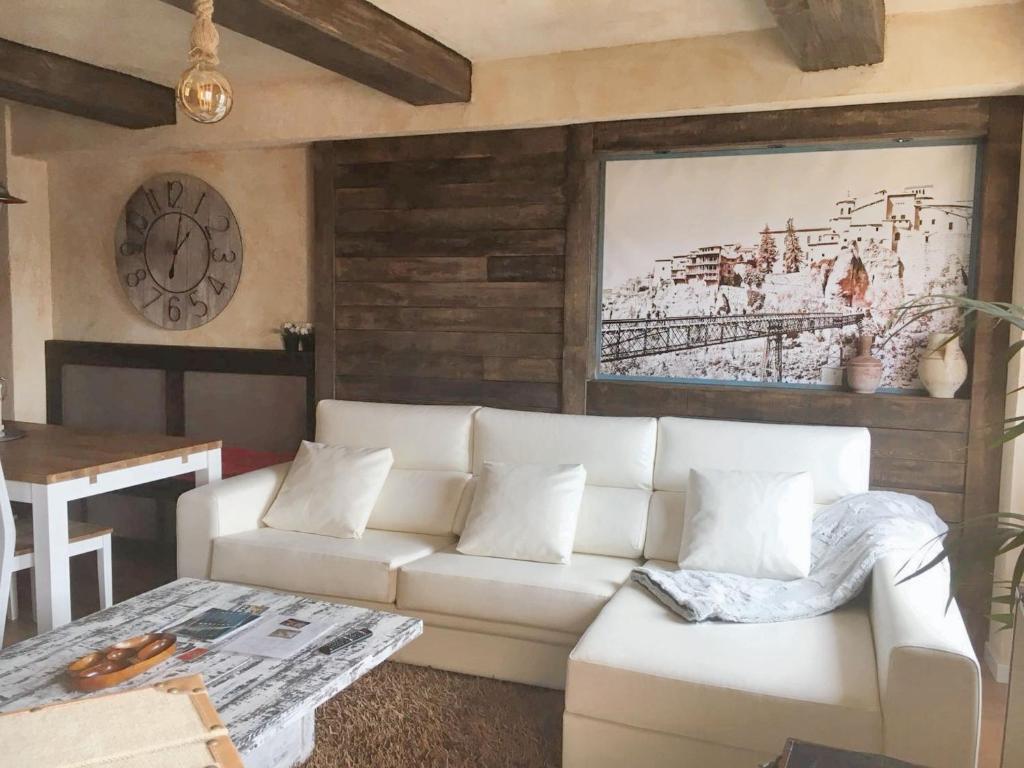 a living room with a white couch and a table at Charming apartment in Cuenca with fireplace - 80 sqm in Cuenca