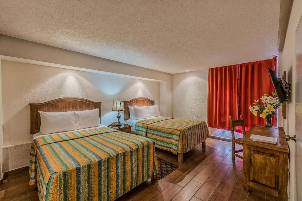 Postel nebo postele na pokoji v ubytování Hotel Chocolate Carruaje