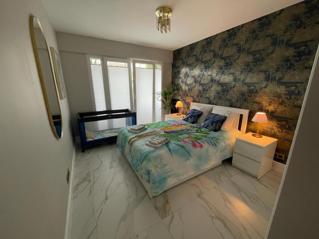 a bedroom with a large bed and two night stands at St George in Antibes