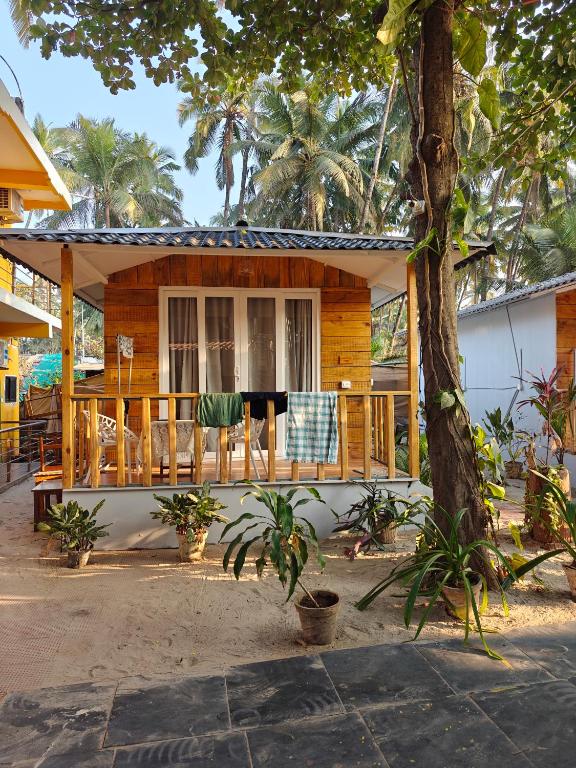 a house with a porch with chairs on it at Rococo Pelton beach huts Palolem Beach goa in Palolem