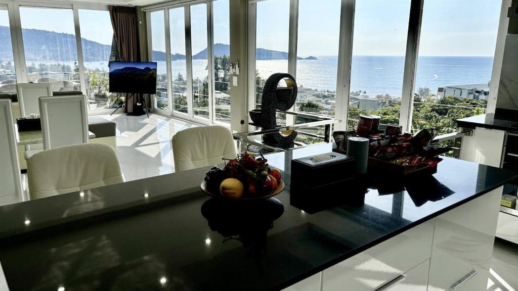 a kitchen with a counter with a view of the ocean at Sawansa 33A 400m2 Luxury Seaview Pool near Beach in Patong Beach