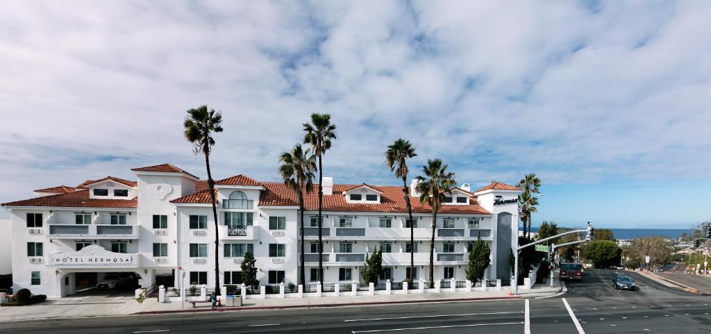 a large house with a large clock on the front of it at Hotel Hermosa in Hermosa Beach
