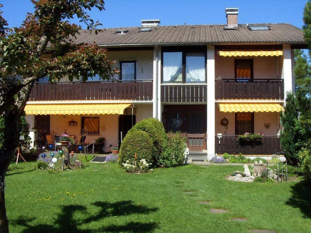 une grande maison avec une pelouse devant elle dans l'établissement Beim Bergfreund, à Füssen