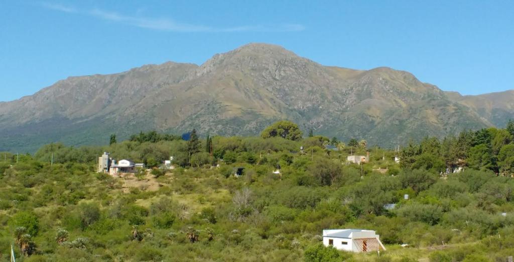 a small village in front of a mountain at Habitación privada en casa rural, vistas Uritorco in Capilla del Monte