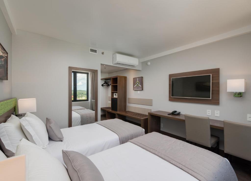 Cama ou camas em um quarto em Linx Confins