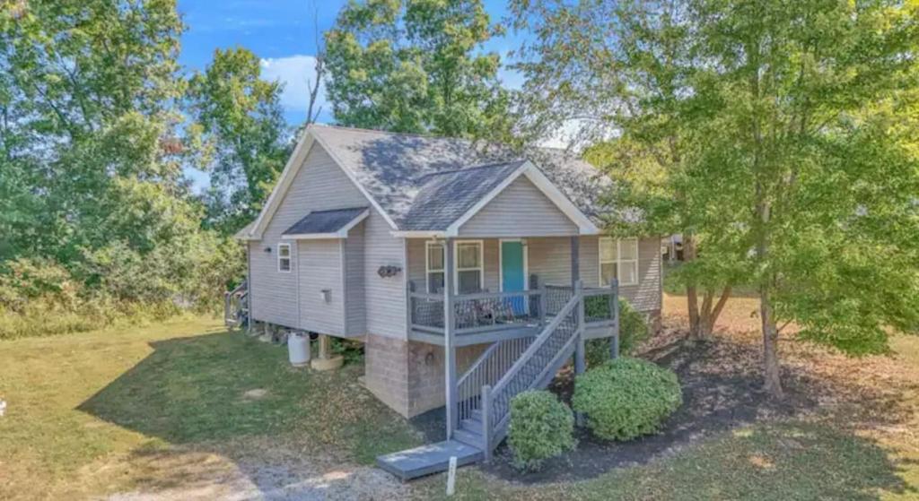 a small house with a slide in front of it at Whiskey River Lake Retreat in Taylorsville