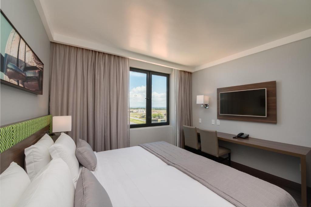 Cama ou camas em um quarto em Linx Confins