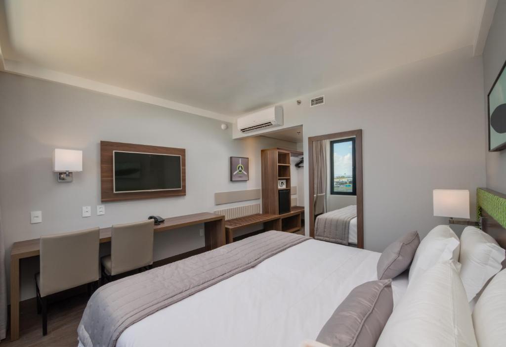 Cama ou camas em um quarto em Linx Confins