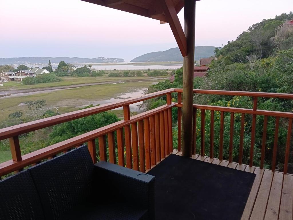 a balcony with a view of a river and mountains at Phoenix 34South in Knysna