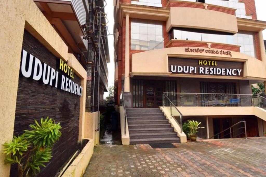 a building with a hotel with a stairway in front of it at Hotel Udupi Residency near Shri Krishna Mata, Udupi in Udupi