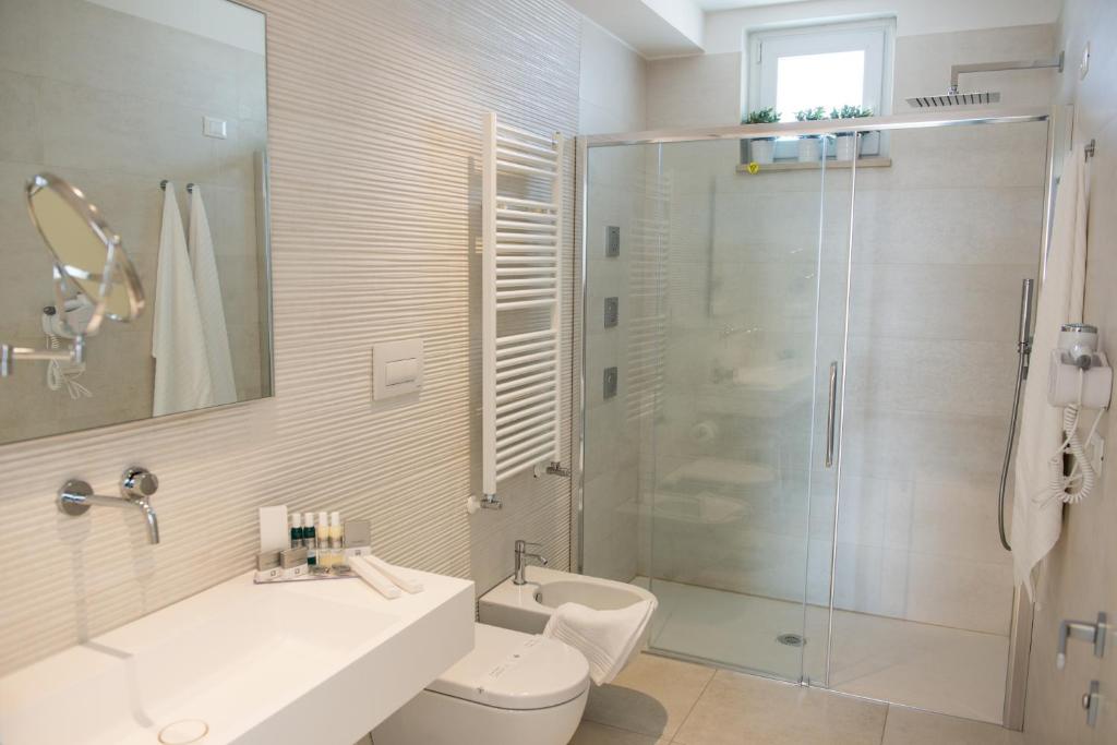 a bathroom with a shower and a sink and a toilet at Hotel Cicò in Torre Santa Sabina