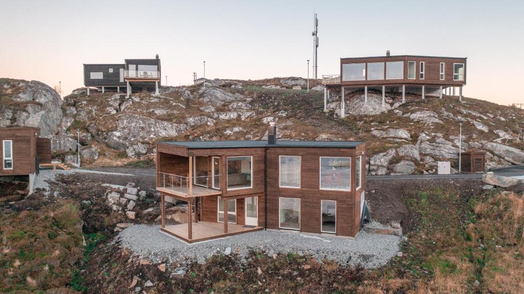 a house on top of a hill with buildings at Runde Panorama - Østen Pilot in Terøy