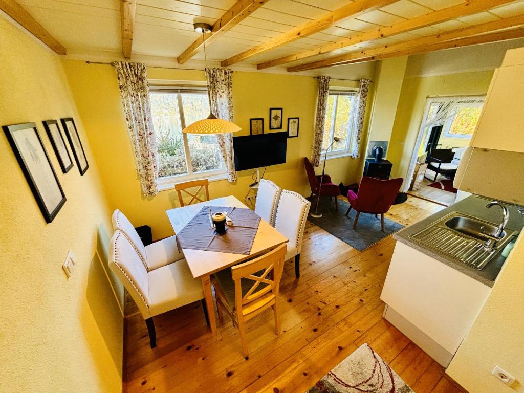 a kitchen and dining room with a table and chairs at Familienchalets am Millstätter See in Rothenthurn