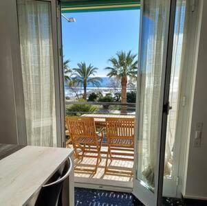 an open door to a patio with a view of the ocean at Rivamare 3 Bilocale Fronte Mare in Marina dʼAndora